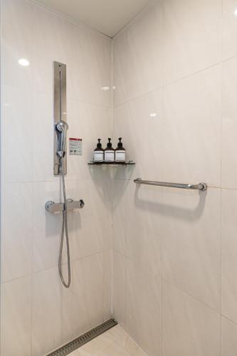 a shower stall with a phone in a bathroom at Hotel Modak Namdaemun in Seoul