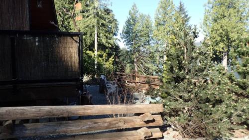 a wooden fence in front of a forest at Wild Coast Chalets in Port Renfrew