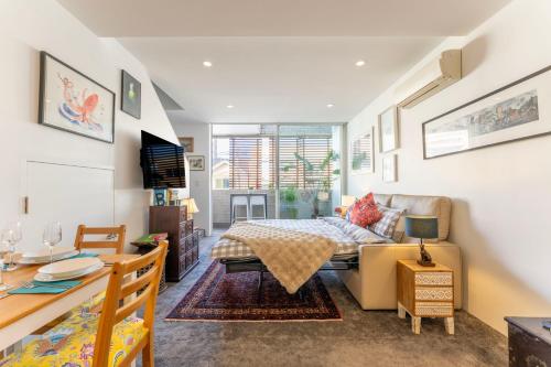 a bedroom with a bed and a living room at Elegant Apartment, Heart of Newtown with Secure Parking in Sydney