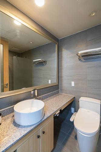 a bathroom with a sink and a toilet and a mirror at Hotel Modak Namdaemun in Seoul