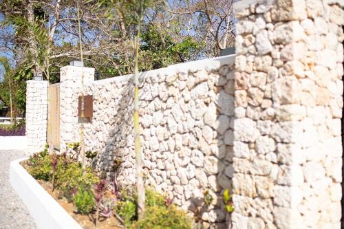 a stone fence with a stone wall at Tesoro Villas in Río San Juan
