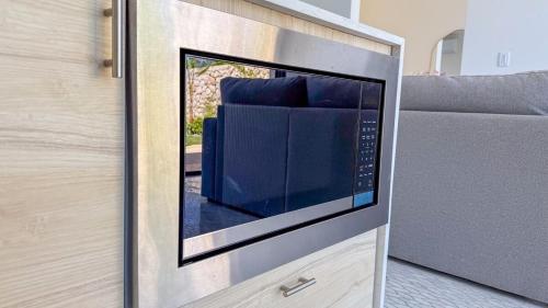 a microwave oven in a kitchen with a couch at Tesoro Villas in Río San Juan