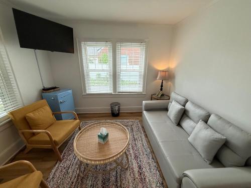 a living room with a couch and a table at Island Guesthouse and Motel OBX in Manteo