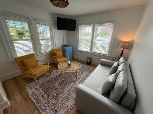 a living room with a couch and two chairs and a table at Island Guesthouse and Motel OBX in Manteo