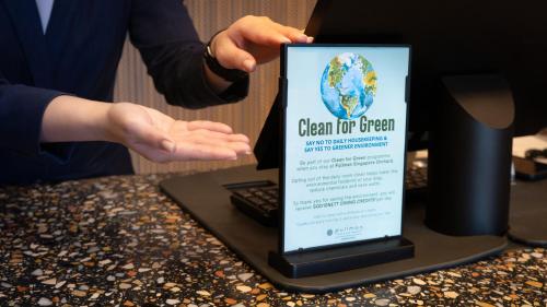 a person is holding up a sign on a laptop at Pullman Singapore Orchard in Singapore
