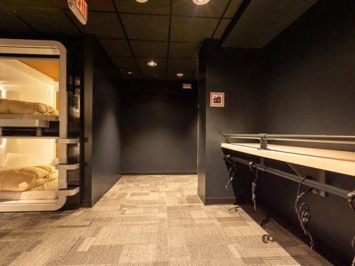 a room with an open refrigerator and a hallway at First Cabin International Hawaii in Honolulu