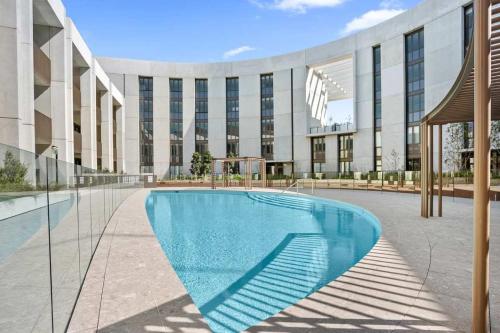 a swimming pool in front of a building at Marinafront Retreat Shell Cove in Shellharbour