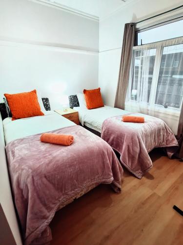 a bedroom with two beds and a window at Regent Residential House in Whangarei
