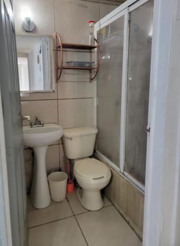 a bathroom with a toilet and a sink and a shower at Águilas Room 2 camas in Guadalajara