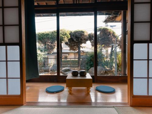 a room with a table and a large window at Izumi Tei 泉邸100m2 旅館風一軒家 family friendly villa in Kitakyushu