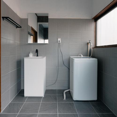 a bathroom with a shower and a toilet in it at Izumi Tei 泉邸100m2 旅館風一軒家 family friendly villa in Kitakyushu