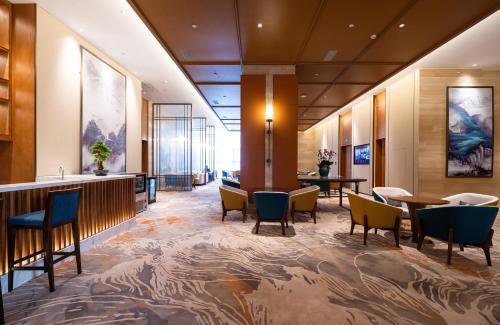 a lobby of a hotel with chairs and tables at Shangrao International Hotel in Shangrao