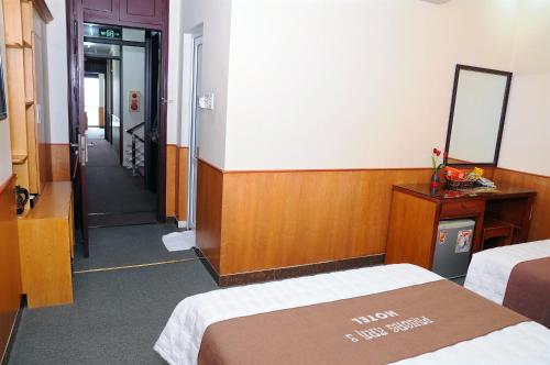 a hotel room with two beds and a hallway at Phuong Anh 3 Hotel in Hai Phong