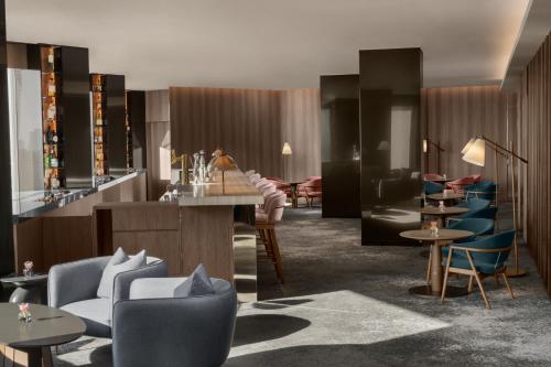 a lobby with a bar and chairs and tables at ANA InterContinental Tokyo by IHG in Tokyo