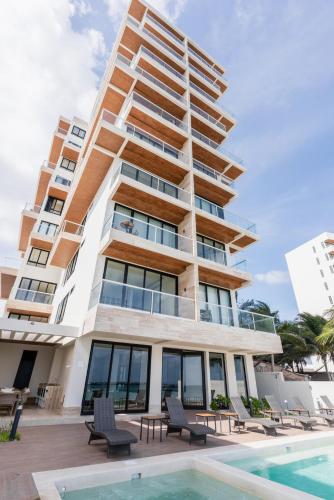 aominium building with a pool in front of it at DM504 Apartment with Spectacular Views in Puerto Morelos