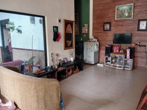 a living room with a couch and a television at Homestay Rumah Akung in Ngadipuro