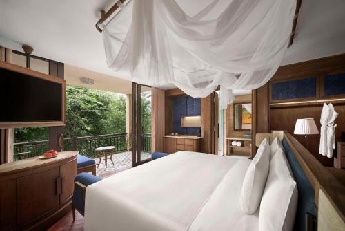 a bedroom with a large bed with a large window at Garrya Mù Cang Chải in Mù Cang Chải