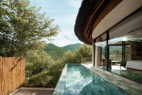 a house with a swimming pool with a view at Garrya Mù Cang Chải in Mù Cang Chải