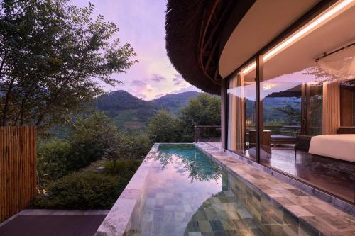 a house with a swimming pool with a view at Garrya Mù Cang Chải in Mù Cang Chải