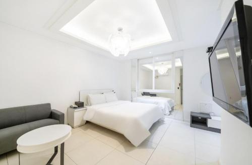 Postel nebo postele na pokoji v ubytování S One Hotel Sangmu