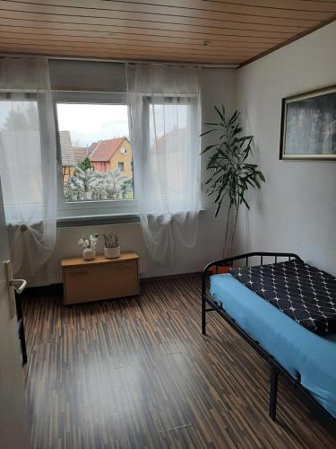 a bedroom with a bed and two windows at Ländliche Erholung 3 in Heideland