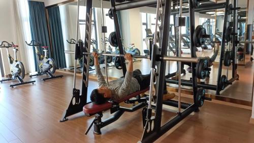a man doing a push up in a gym at Shangrao International Hotel in Shangrao