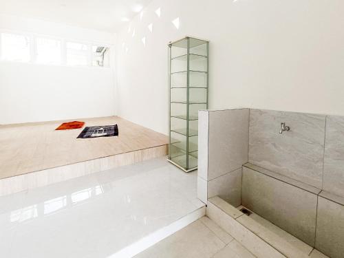 a bathroom with a shower and a mirror at The TAMU HOUSE Syariah Solo RedPartner in Bonorejo