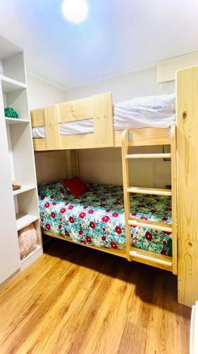 a room with two bunk beds and a wooden floor at Pacific Apartamento Surco in Lima