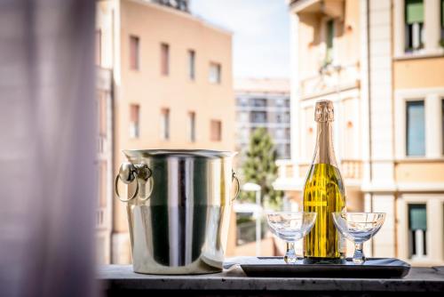 a bottle of champagne and two glasses on a table at Hotel Emmaus in Rome