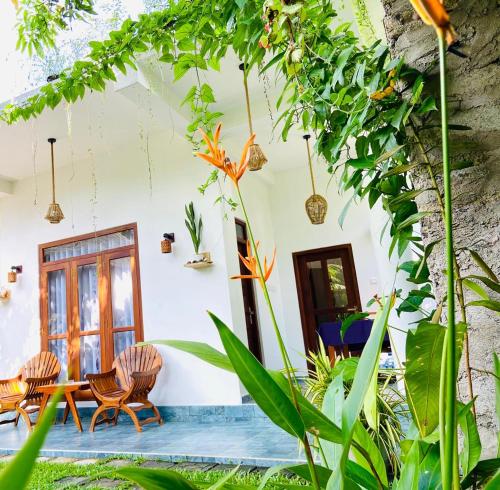a room with a table and chairs and plants at Diamond Key Ahangama in Piyadigama