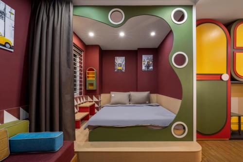 a bedroom with a bed in a house shaped room at Q Apartment Da Nang in Da Nang