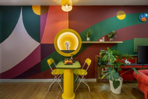 a colorful living room with a table and chairs at Q Apartment Da Nang in Da Nang
