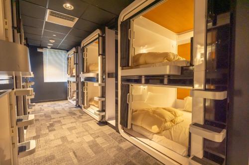 a row of bunk beds in a room at First Cabin International Hawaii in Honolulu