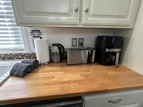 a kitchen counter with a microwave and a coffee maker at Enjoy Privacy - Pine Mountain - Spacious Home in Pine Mountain Club