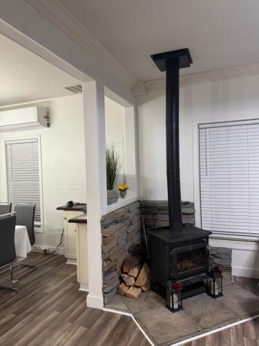 a fireplace in a living room with a stove at Enjoy Privacy - Pine Mountain - Spacious Home in Pine Mountain Club