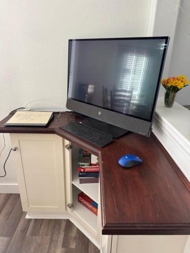 a desk with a computer monitor and a keyboard and mouse at Enjoy Privacy - Pine Mountain - Spacious Home in Pine Mountain Club