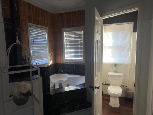 a bathroom with a bath tub and a toilet at Enjoy Privacy - Pine Mountain - Spacious Home in Pine Mountain Club