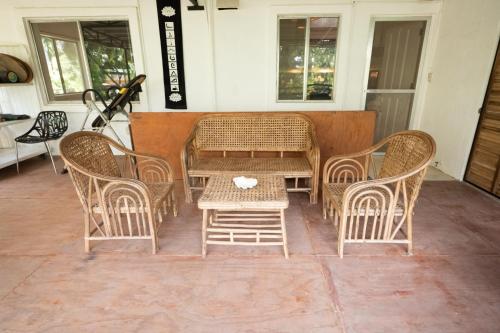 a table and four chairs and a table and a table at RAINFOREST Nest Self-Service Home in Subic Bay - Monkeys, Bats, Roofdeck! in Subic Bay Intl