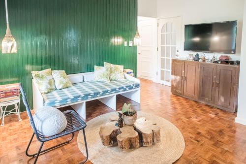 a living room with a couch and a table at RAINFOREST Nest Self-Service Home in Subic Bay - Monkeys, Bats, Roofdeck! in Subic Bay Intl