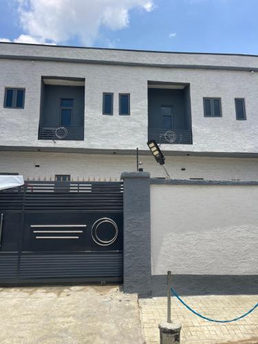 a building with a black gate and a building with windows at Extravaganza Stay in Lagos