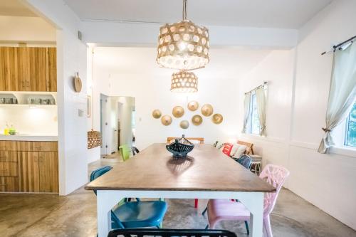 a kitchen and dining room with a table and chairs at RAINFOREST Nest Self-Service Home in Subic Bay - Monkeys, Bats, Roofdeck! in Subic Bay Intl