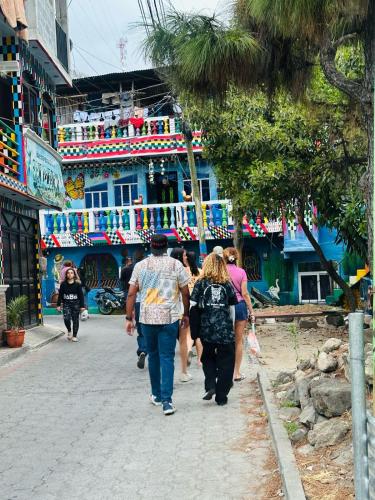 a group of people walking down a street at Encanto junto al lago en la zona viva in San Pedro La Laguna