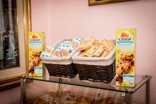 two baskets of cookies on a glass table at Hotel Emmaus in Rome