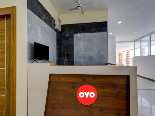 a red sign on a wooden door in a room at Hotel O B.S Celebration in Lucknow