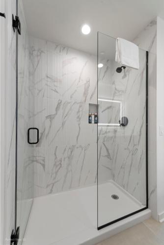 a shower with a glass door in a bathroom at K2 Sky High Apartments with Stunning Chicago Views in West Loop in Chicago