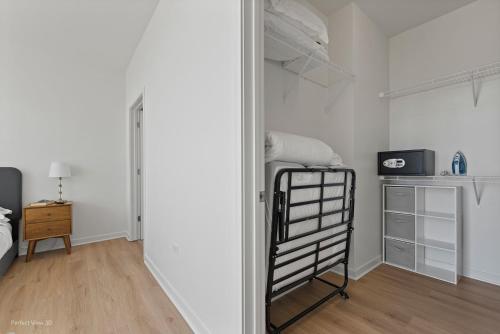 a bedroom with white walls and a bunk bed at K2 Sky High Apartments with Stunning Chicago Views in West Loop in Chicago