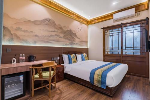a bedroom with a bed and a desk with a chair at Peking Courtyard Qianmen in Beijing