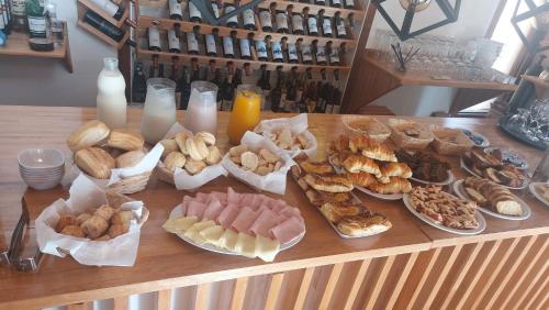 a table filled with different types of food and drinks at Hotel Salto Grande in Federación