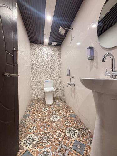 a bathroom with a sink and a toilet at Lords Grey near Mall Road in Shimla