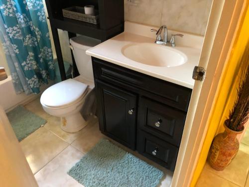 a bathroom with a sink and a toilet at 2 Bed-Sleeps 4-Gated community-5 Min Town Centre in The Rock
